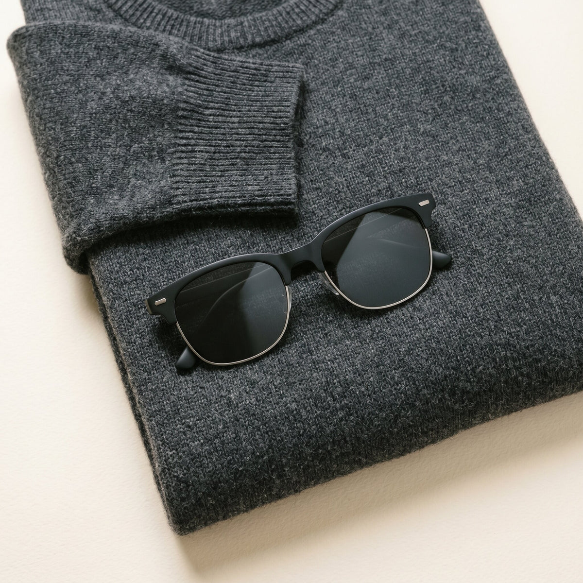 The Brow in Matte Black polarized sunglasses styled on natural fabric